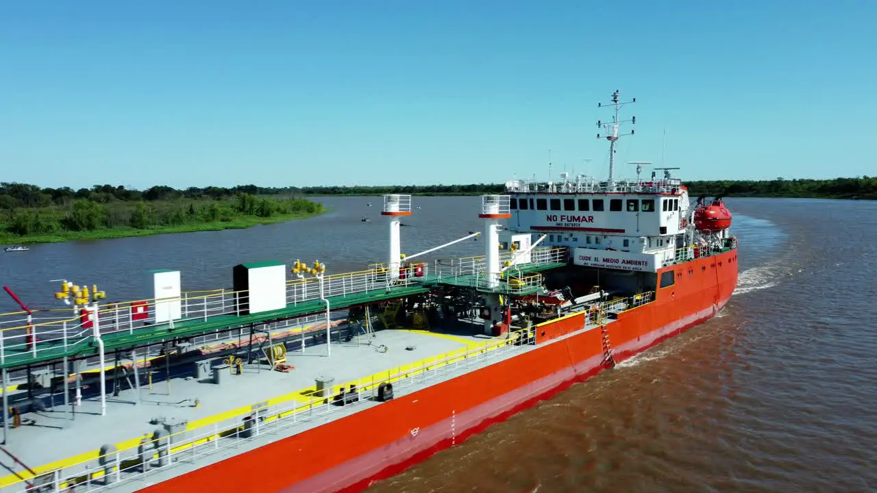 Oil transportation ship navigating through a small river