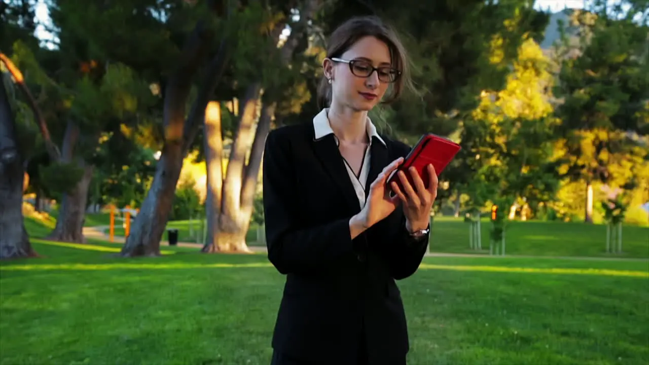 Attractive caucasian business woman dials a contact on her phone and has a happy conversation