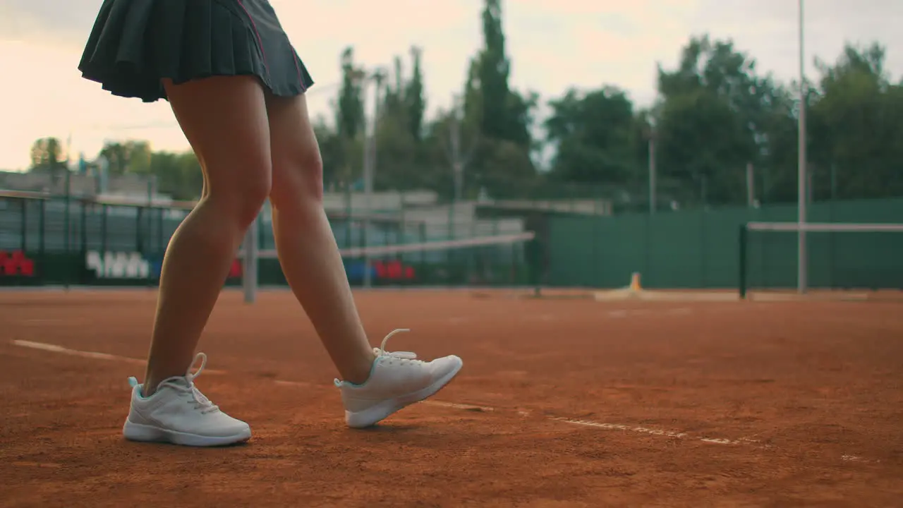 Slow motion close up Young Caucasian teenager female tennis player serving during a game or practice Tennis Player Serving On The Clay Court