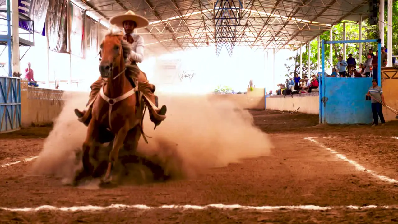 Charros Mexican cowboys performing tricks during a Charreada a horse rider competition