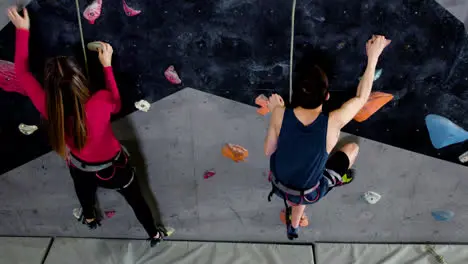 Teenage boy and girl climbing indoors