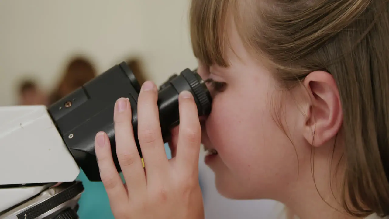 Girl using microscope 