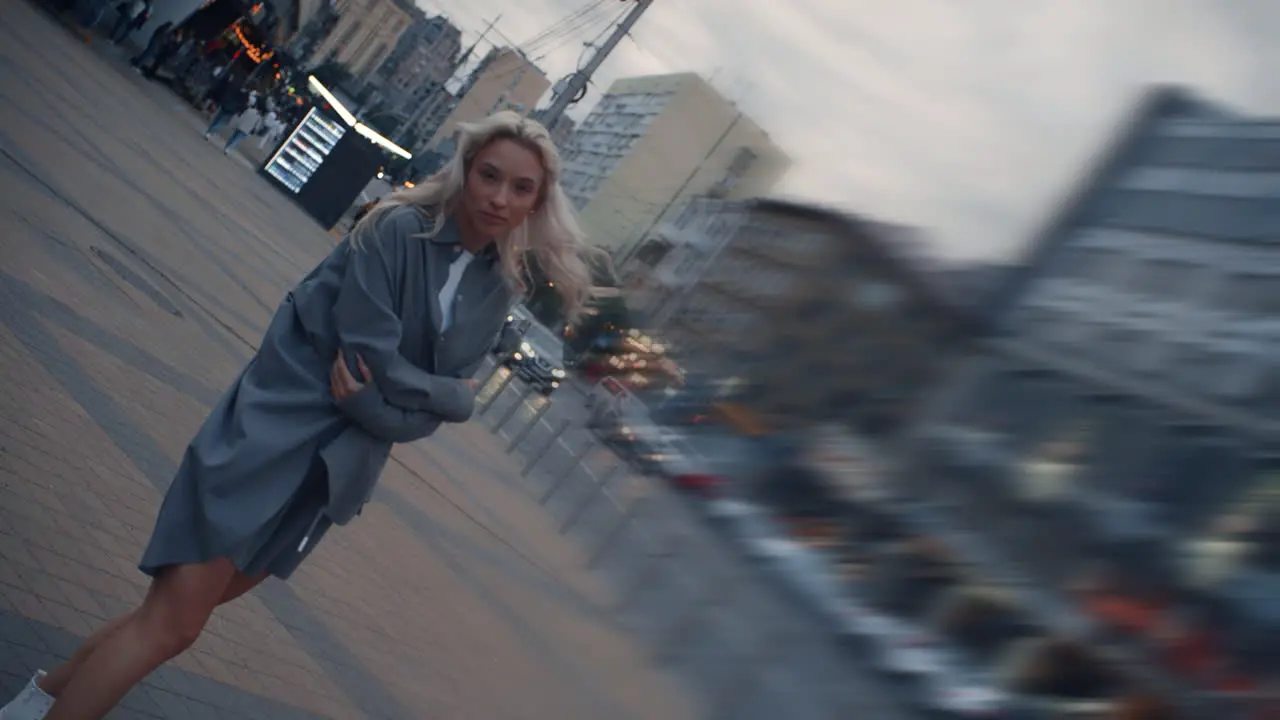 Model posing beautiful cityscape at evening town near road cars