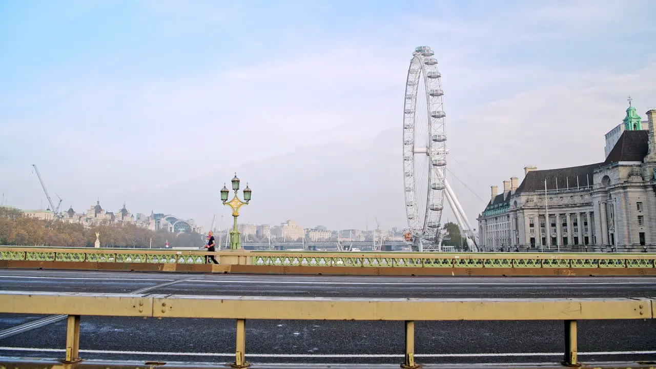 Quiet and empty roads at rush hour in London in Coronavirus Covid-19 lockdown with deserted streets at Westminster Bridge and London Eye no traffic or cars and people walking for commuting