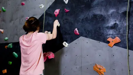 Teenage boy climbing indoors