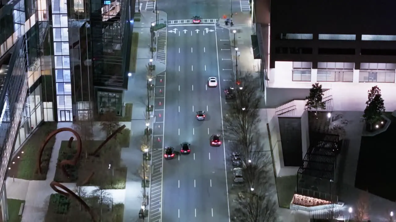 Aerial tilt up shot of cars on multi-lane road in Atlanta City at night and Skyscraper Buildings in background