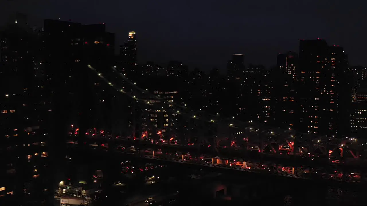 Aerial shot moves closer to the Queensboro 59th Street Bridge in New York City at twilight