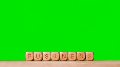 Business Concept Wooden Letter Cubes Or Dice Spelling Business Against Green Screen