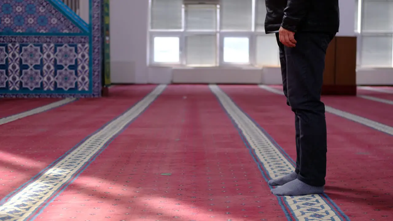 Masked Old Man Mosque Kneels in Prayer