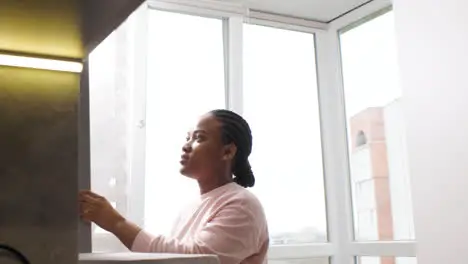 Woman taking an avocado from the fridge