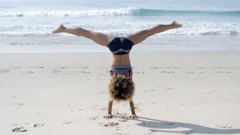 Girl Doing A Handstand On A Beach