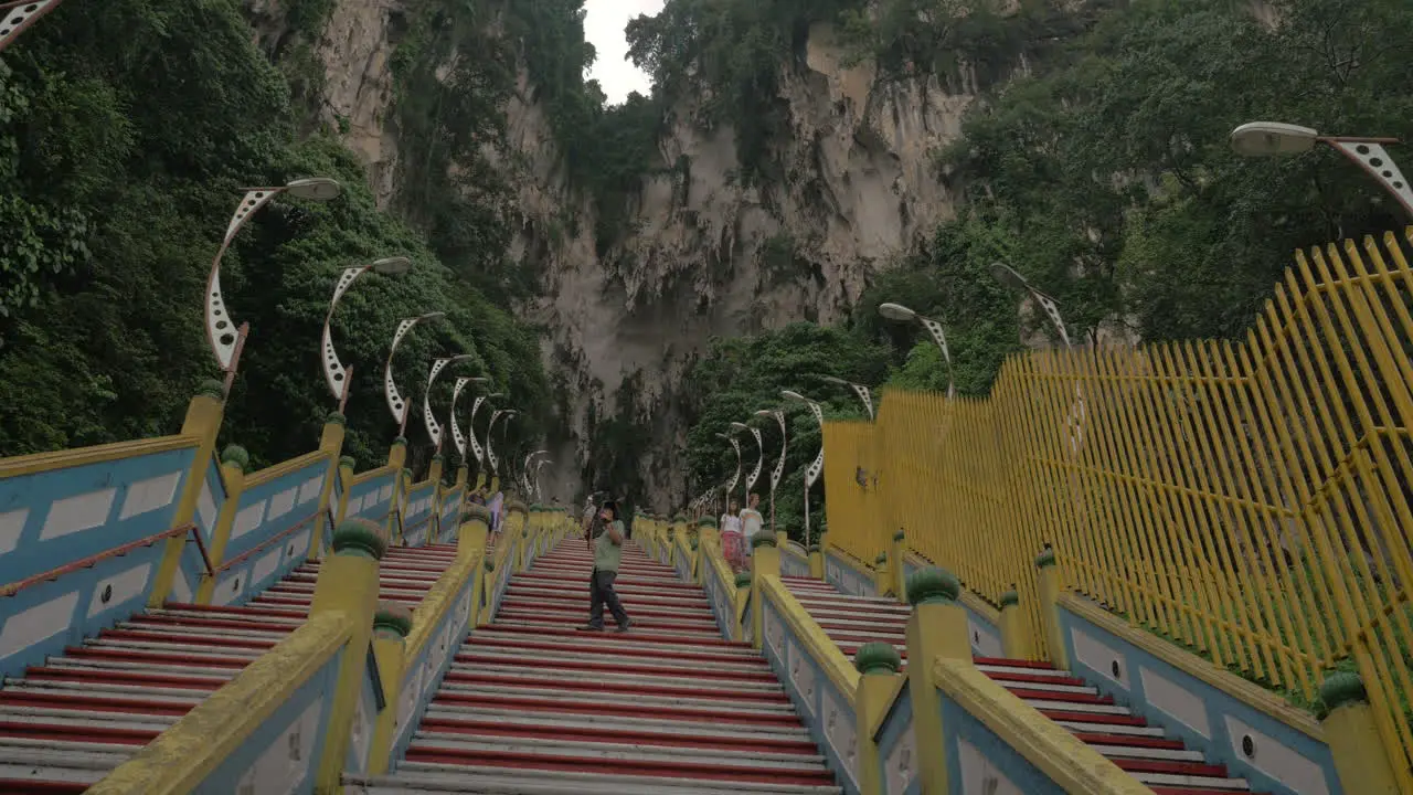 In Batu Caves seen long stairs and mountain with greenery