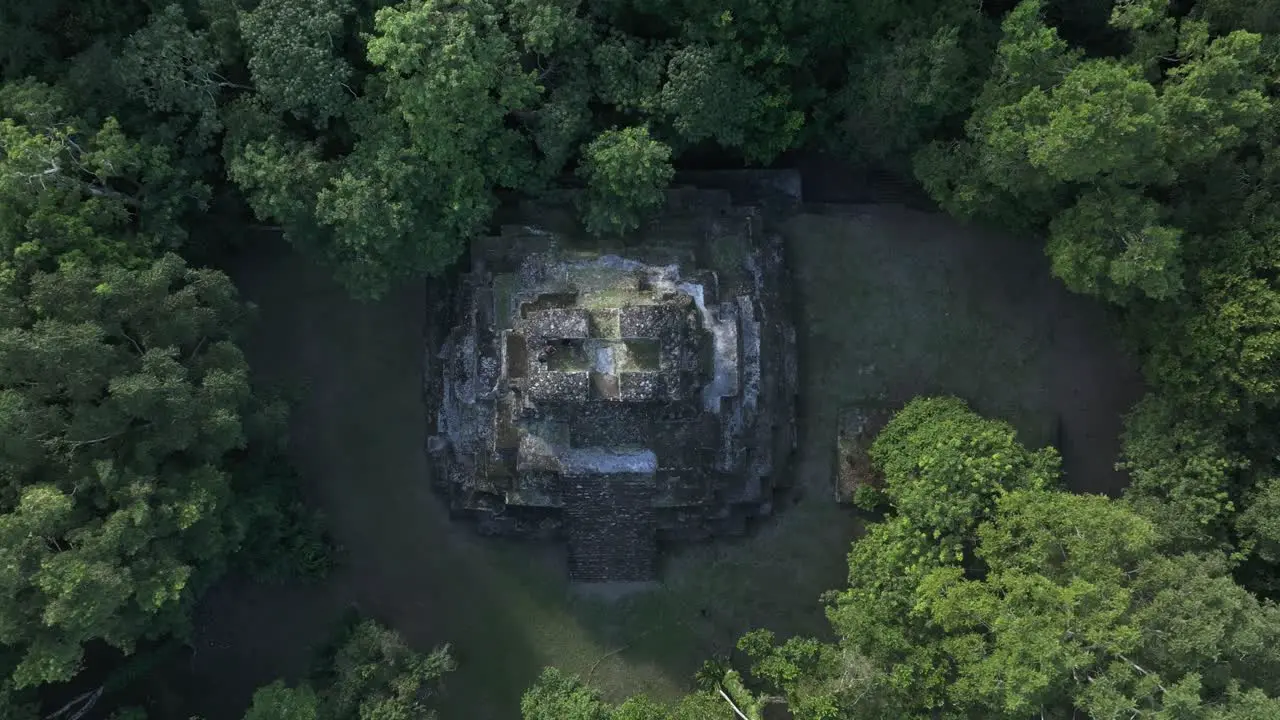 Flying towards mayan pyramid at Yaxha Tikal national park aerial