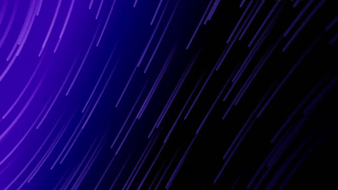 Animation of light trails falling against copy space on purple gradient background