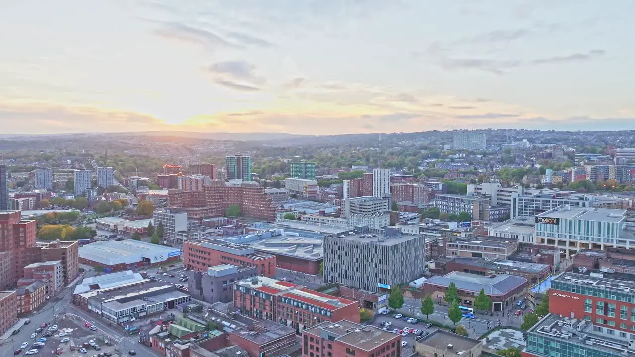 Drone shot large urban city landscape at summer sunset in England