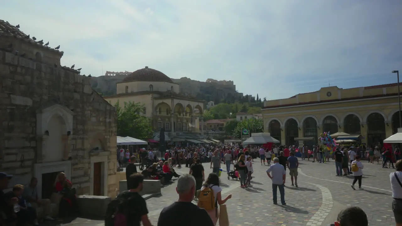 Busy Athens square with Acropolis view tourists and locals