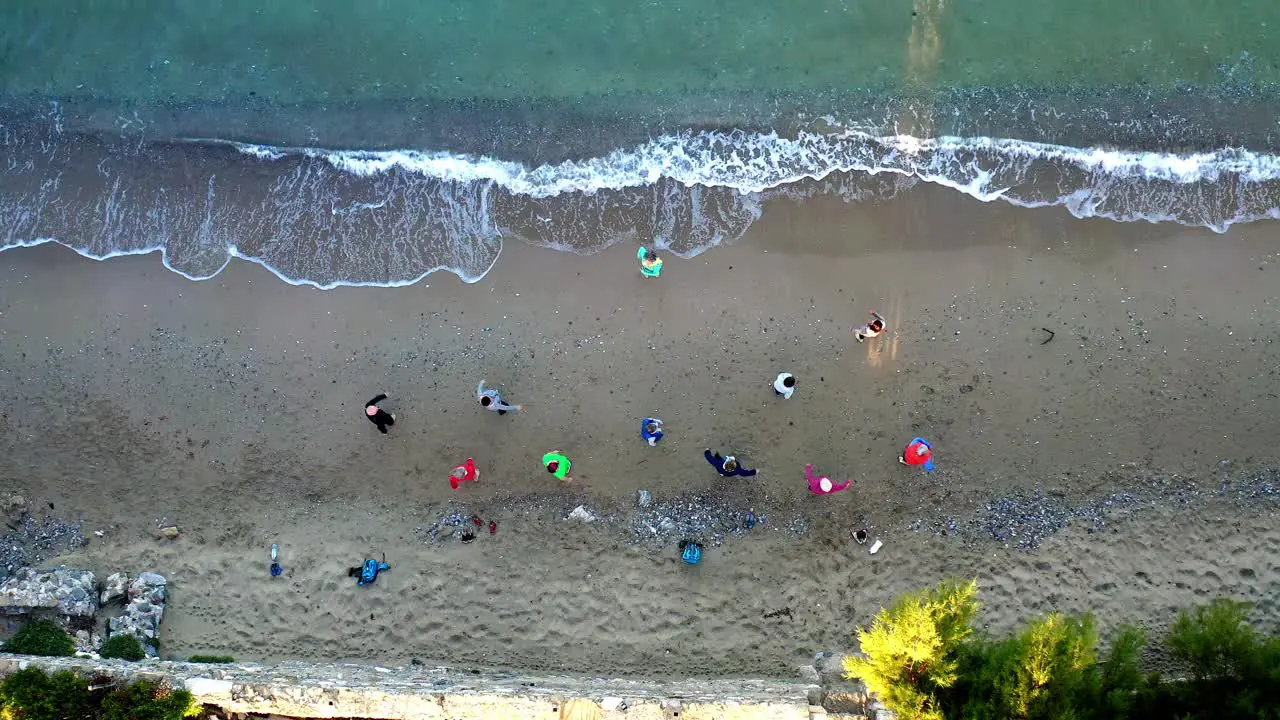 10 people of Yoga Class on the Beach Aerial Top View Drone Shot