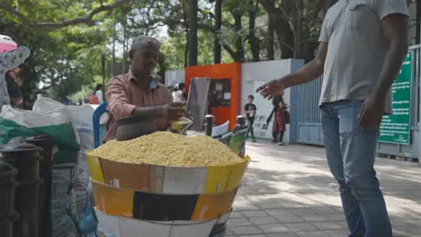 Street Vendor Selling Snacks Outside Entrance To Jawahar Bal Bhavana Recreation Area In Bangalore India