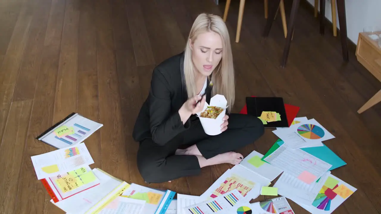 Young business woman working and eating asian food