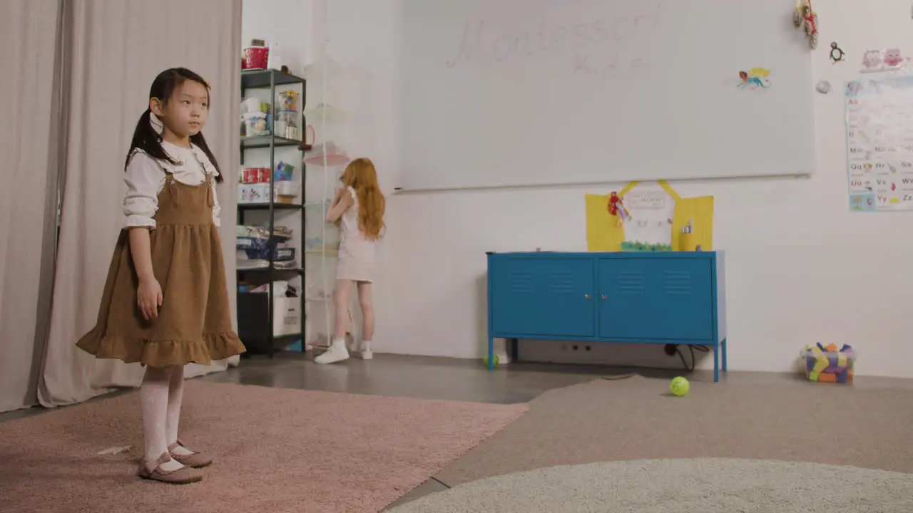 Little Girl Spinning In Classroom In A Montessori School