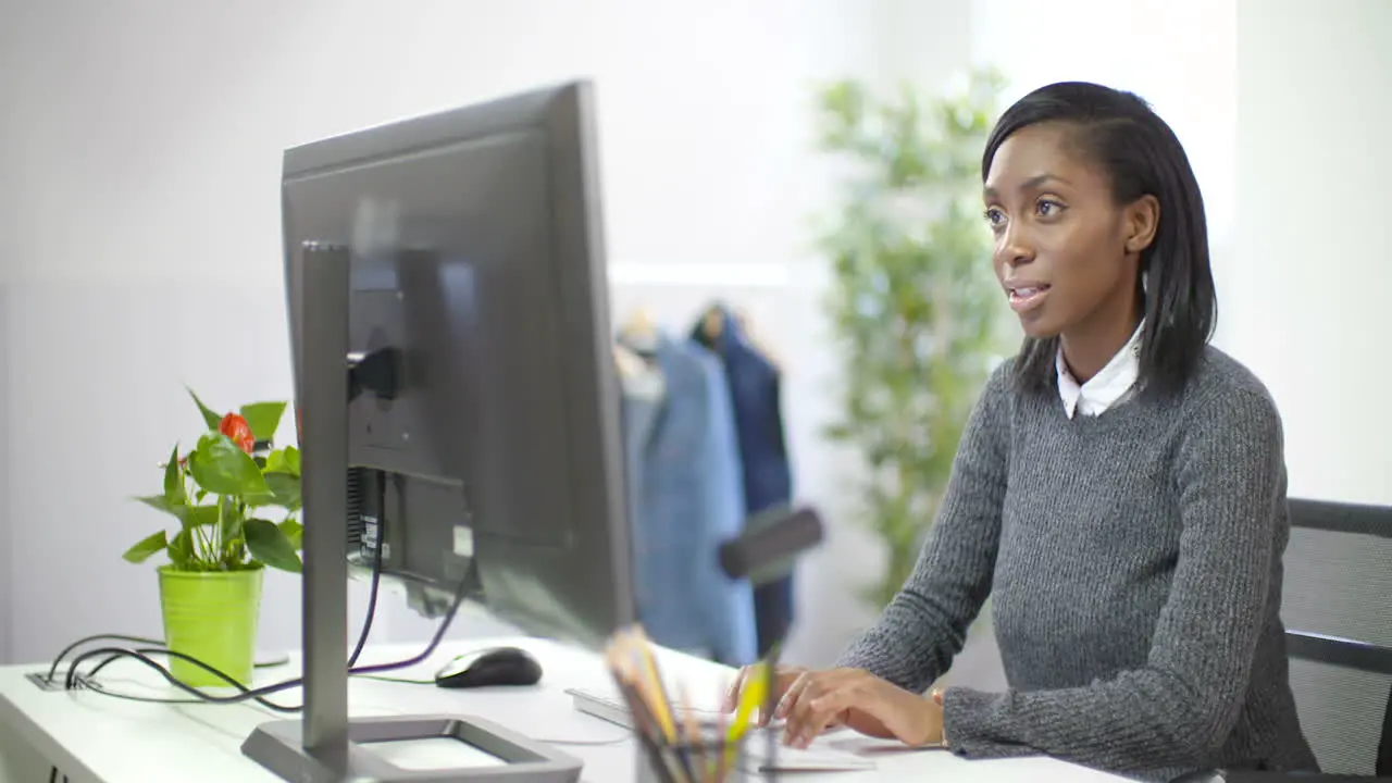 Young Female Professional Working at Desk 1