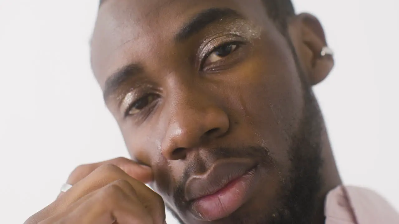 Close Up Male Model With Make Up Crying And Cleaning His Tears