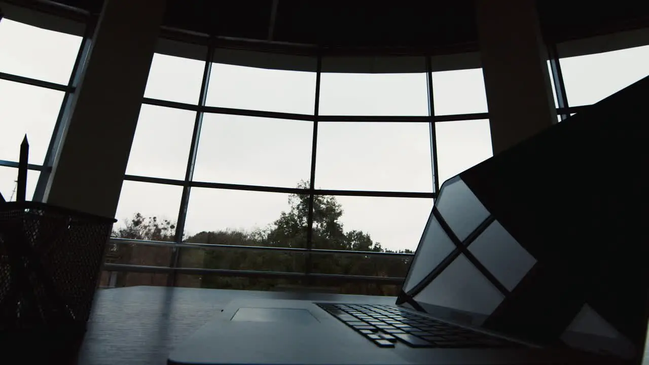 Silhouettes of two businessmen meet in a spacious hall by the window 1