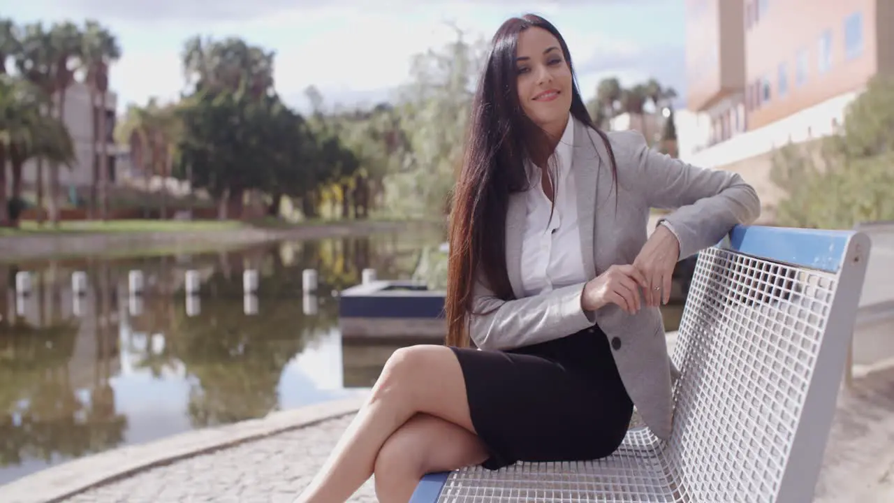 Gorgeous business woman sitting on bench