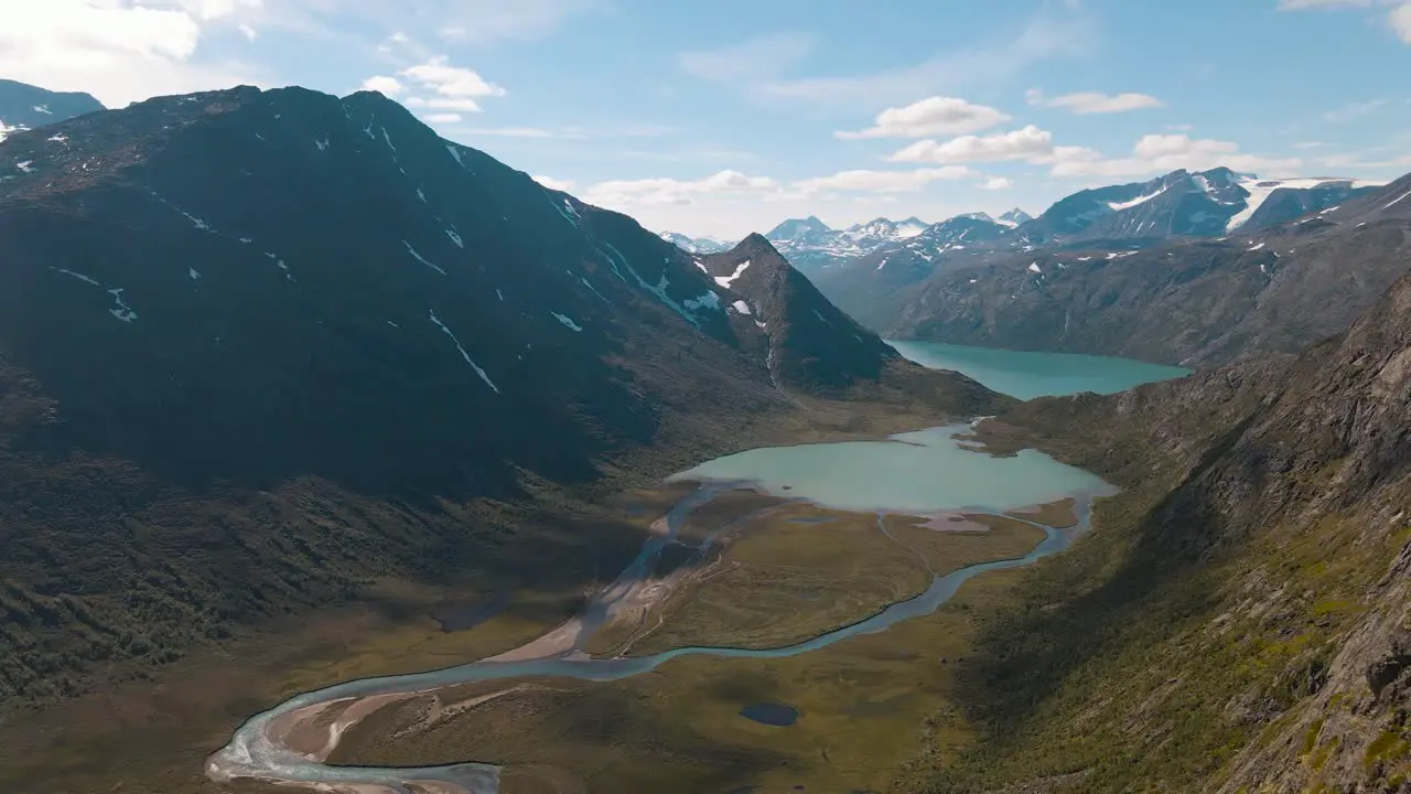 A river flows through the valley into the Ovre Leirungen and can be seen from the Knutshoe the girl admires the beautiful scenery in Norway