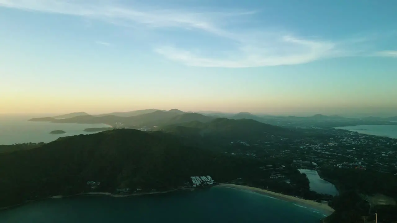 4K Cinematic nature aerial footage of a drone flying over the beautiful beaches of Promthep Cape in Phuket Thailand during sunset