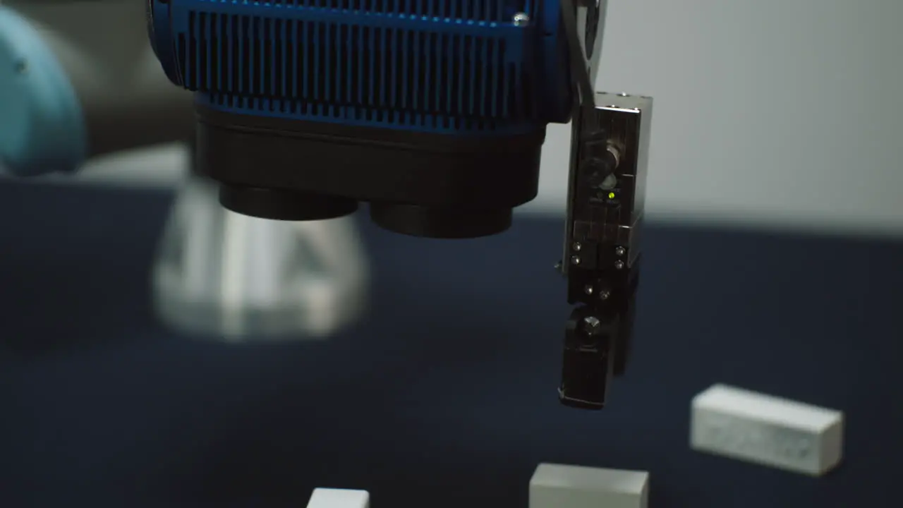 A Robot Arm moving around picking up small bricks