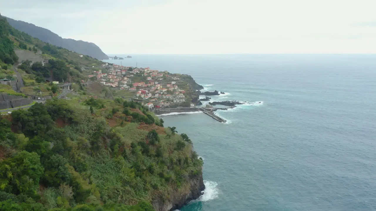 Seixal Madeira Coastline drone shot with waves mountains clouds panoramic Ocean Horizon with cliffs panorama drone shot