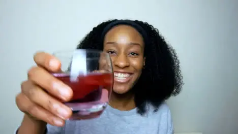 Young Student Talking and Raising Glass Directly to Camera