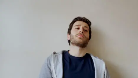 Young Male Student Visibly Bored Whilst Looking Directly into Camera During Remote Lecture