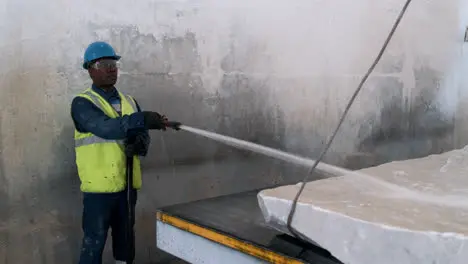 Man cleaning marble piece