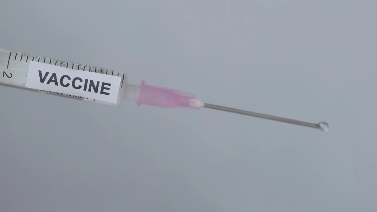 Medical Syringe On White Background Flick By A Physician Close Up Shot