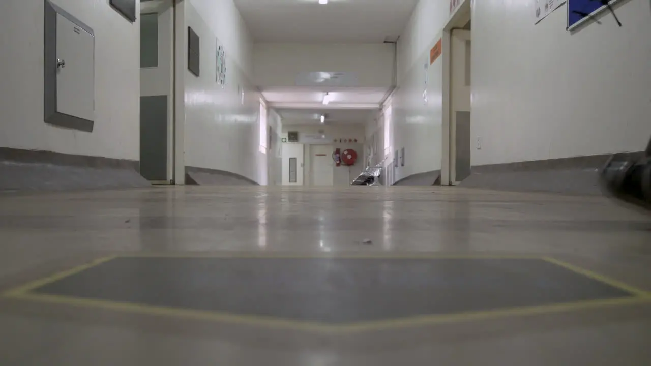 People walk along an unwashed dirty corridor floor at a South African government hospital in Gauteng