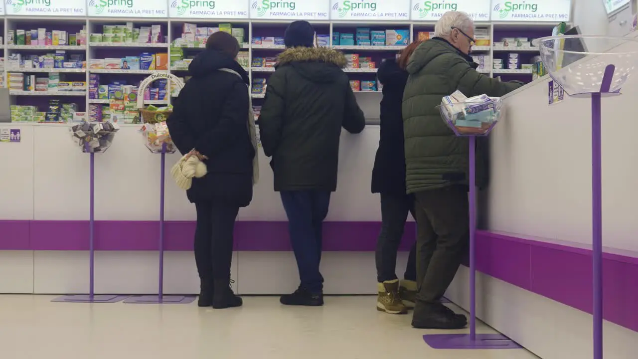 People Waiting At Drugstore Shop Counter