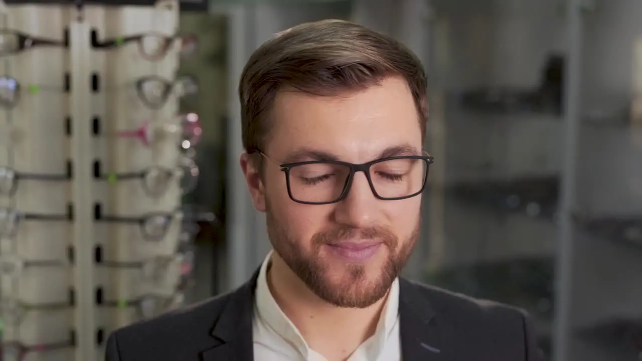 man trying on glasses in store