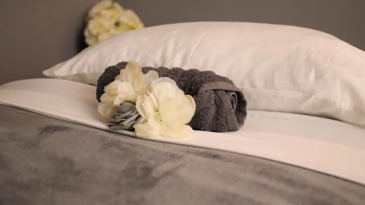 Towel And Flower On A Cosy Spa Bed