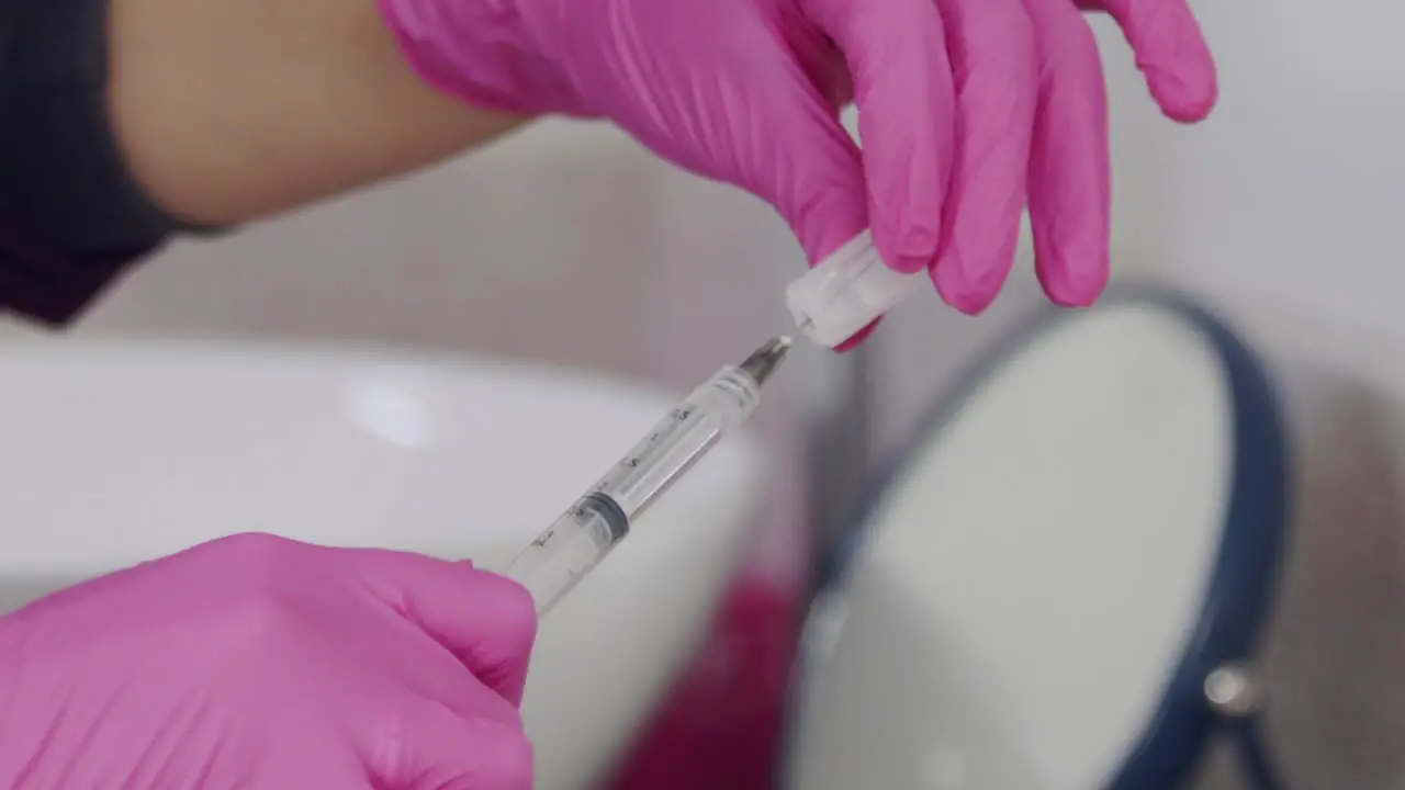 Doctor preparing a syringe and needle for an injection