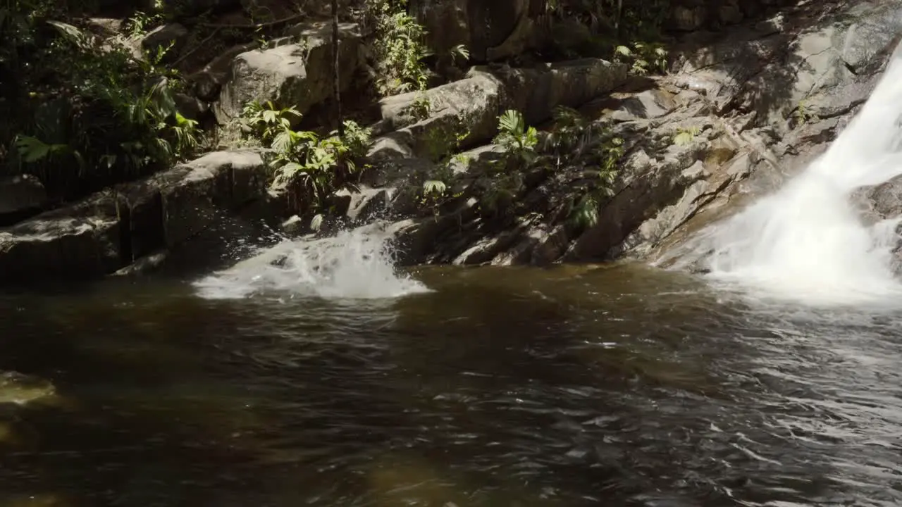 Mahe Seychelles The Sauzier waterfall on Mahé local boy diving inside a waterfall that can be easily reached