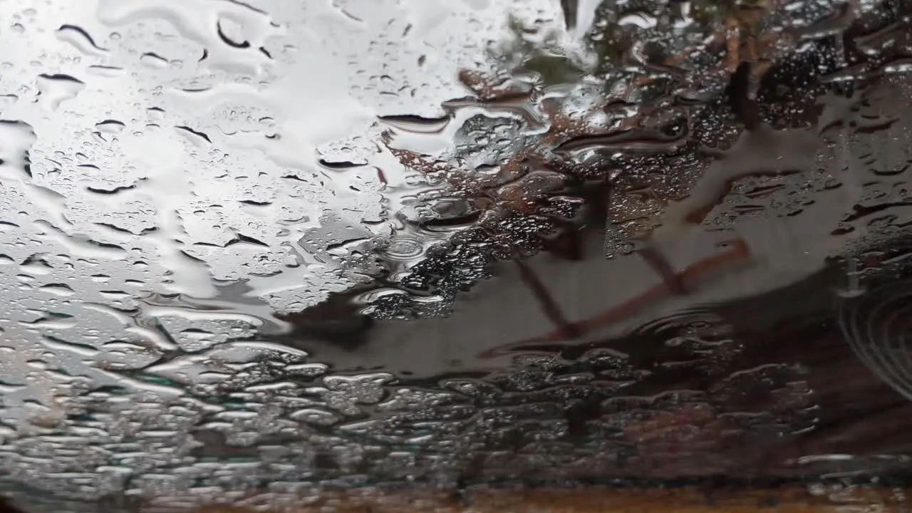 Rain falling on a flat glass sunroof