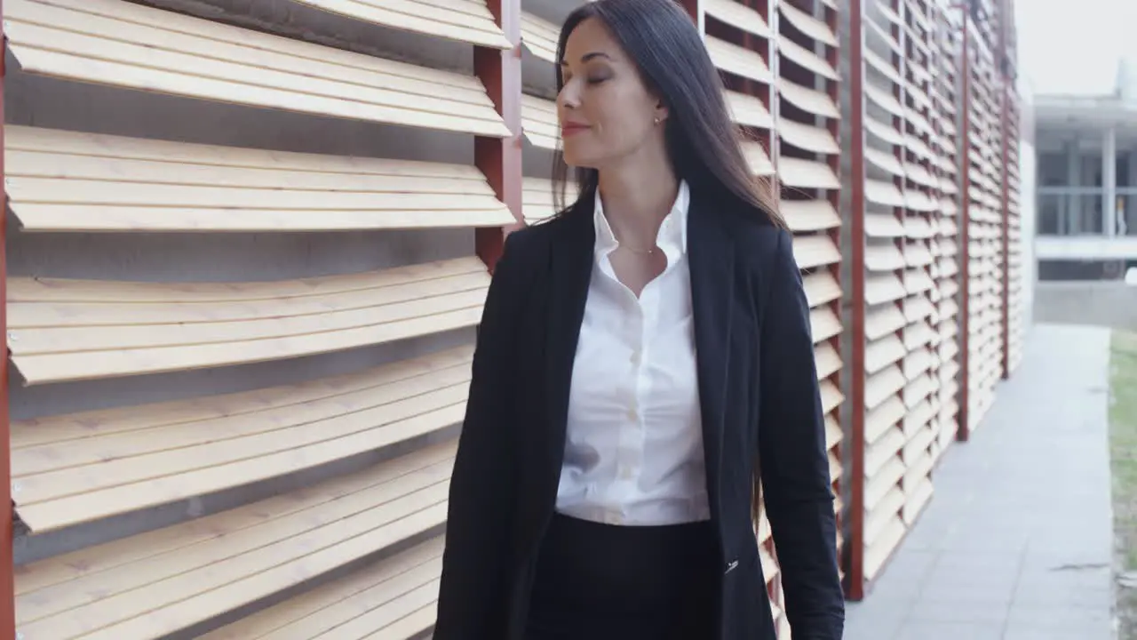 Attractive young woman striding through town