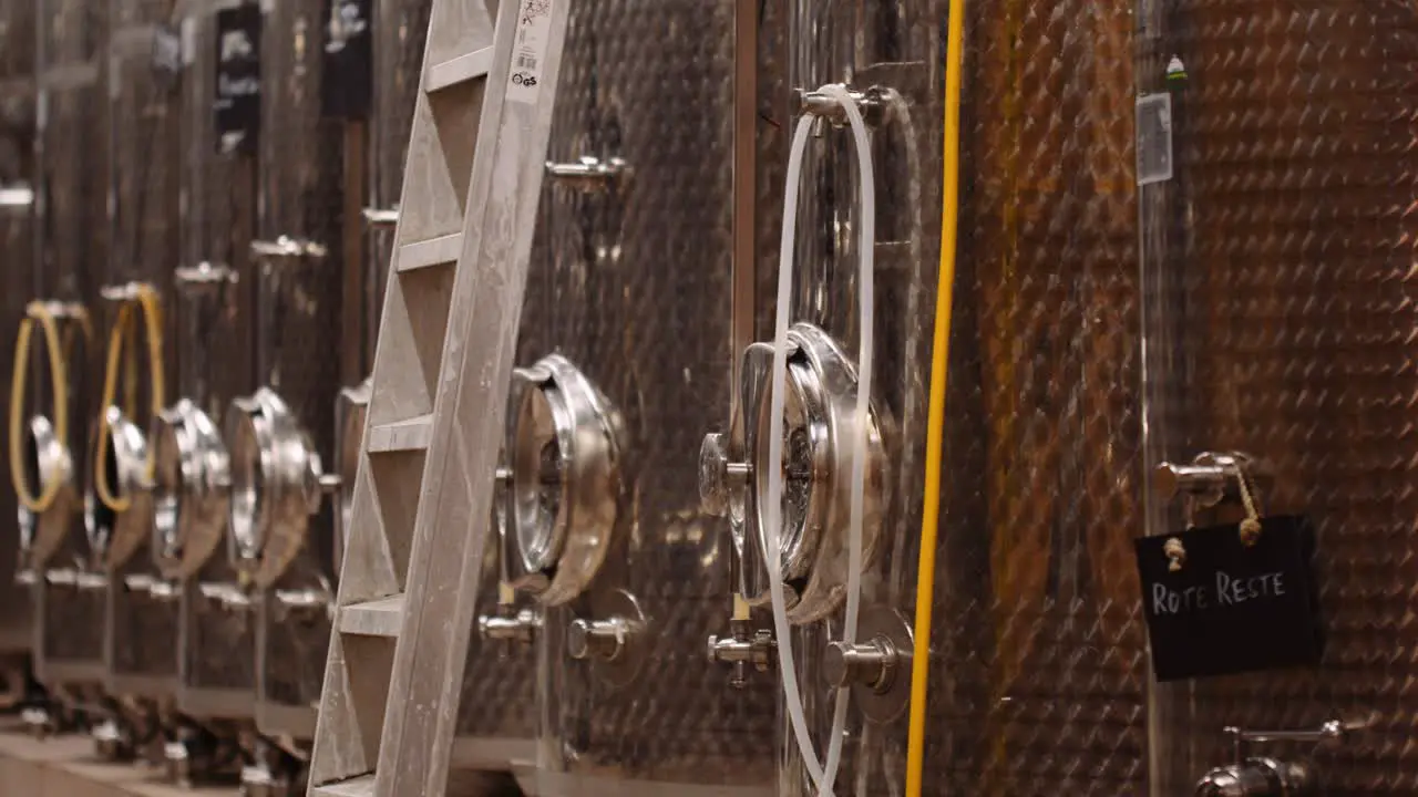 Stainless steel wine tanks in cellar of winery ready for the harvest