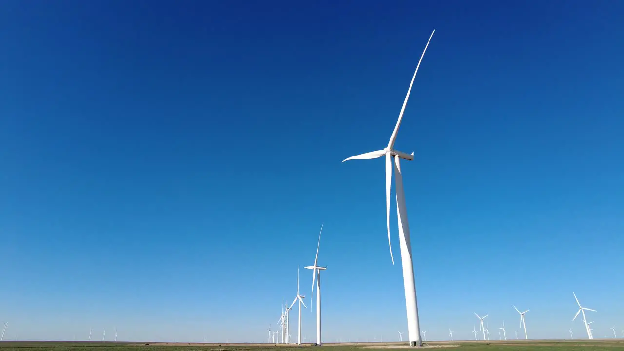 A field of wind turbines slowly spinning in rural west Texas