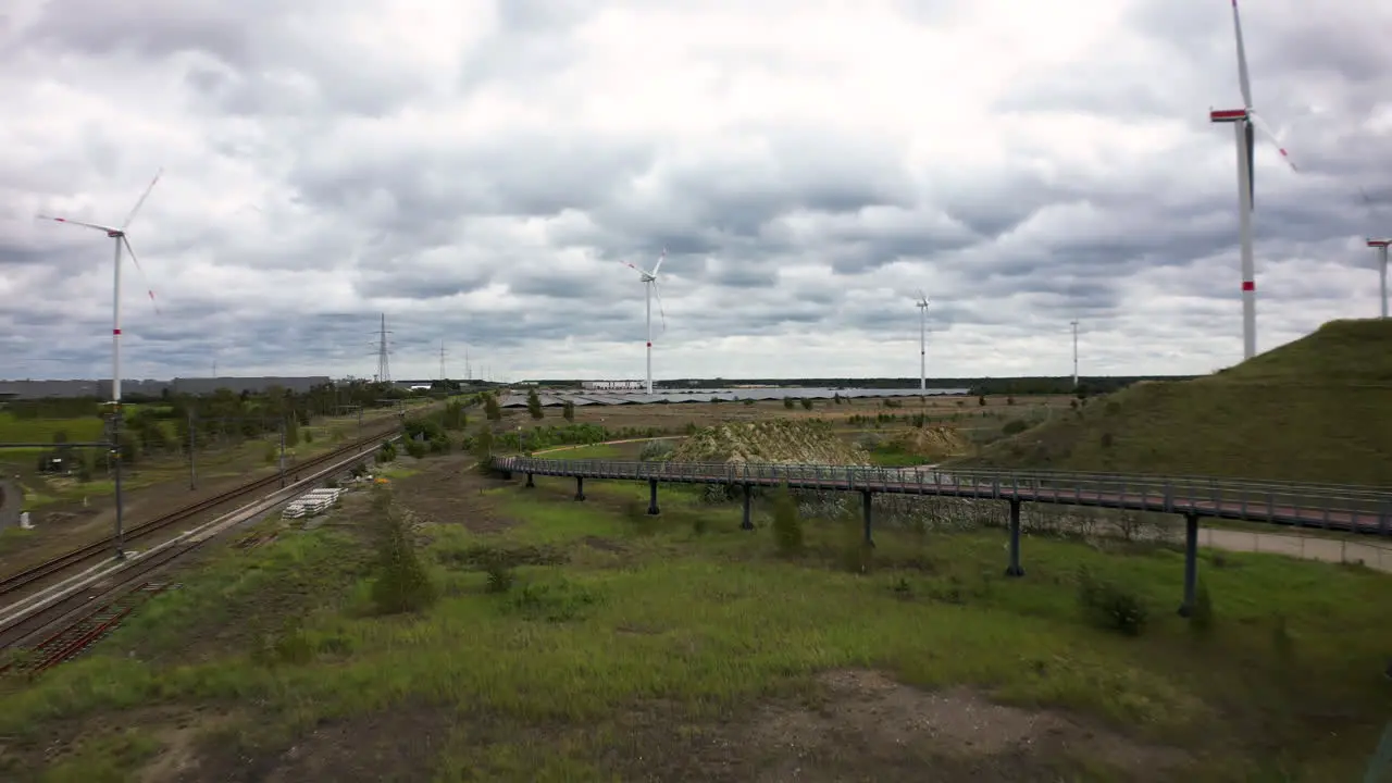 Many wind turbines generate energy near railways aerial view