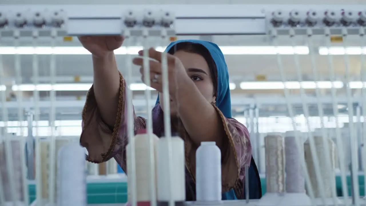 Close-up shot of female worker working in textile factory