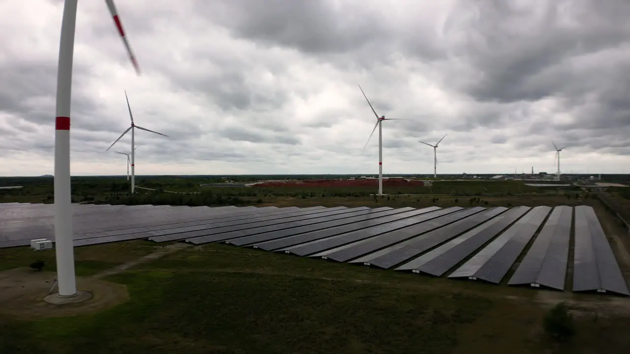 Field of green energy with wind and solar plants aerial view