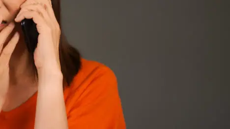 Middle Aged Woman Receiving Bad News On Phone with Copy Space